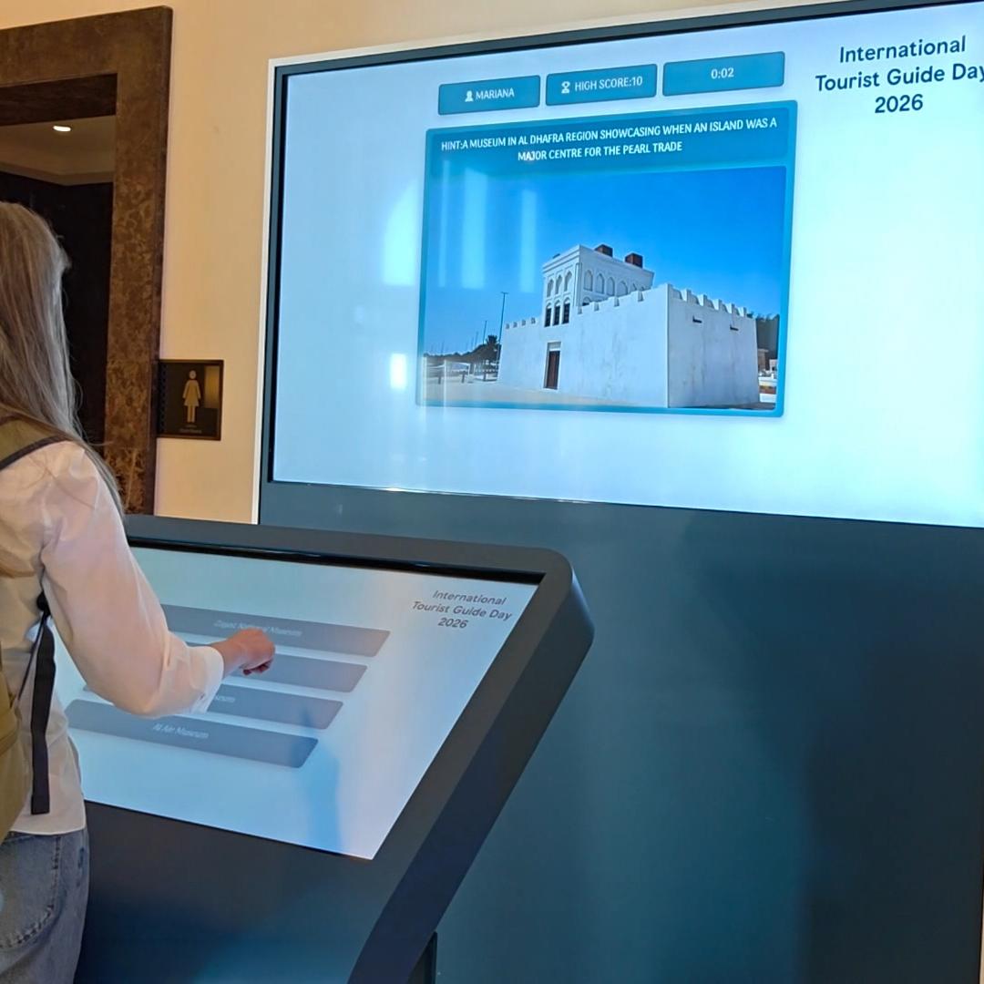 Multi-screen interactive UAE landmark guessing game display with custom branded interface for immersive event activation and digital tourism engagement.